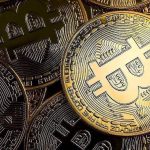 Close,Up,Of,Golden,Coins,With,Bitcoin,Symbol,Background.