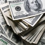 stack of one hundred dollars notes on dollars background