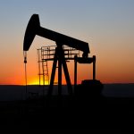 View of Oil Well Pumpjack (Horsehead) at Sunset Oil Industry