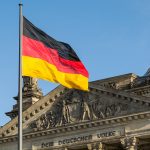 German flag fluttering front of Reichstag building. Berlin, Germany