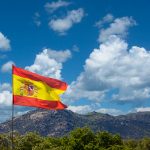 Waving spanish flag in a mountain background