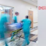 Doctor wheeling patient