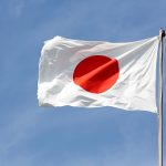 Japanese flag in wind against a blue sky