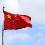 Chinese flag waving in the wind on a sunny day