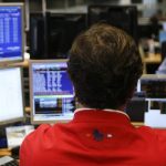 A trader looks at computer screens during a Spanish bond auction in Madrid