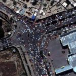 An overview of crowds and trafic at an entrance to Kabul’s airport
