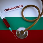 Stethoscope and syringe on Bulgaria flag with coronavirus label