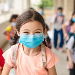 children wearing  face medical mask back to school after covid-19 quarantine