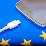 Close up Mobile phone Charger with USB Type – C cord on EU Flag